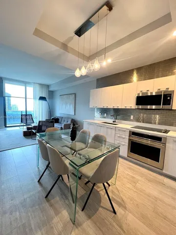 a kitchen with a stove a sink and a refrigerator