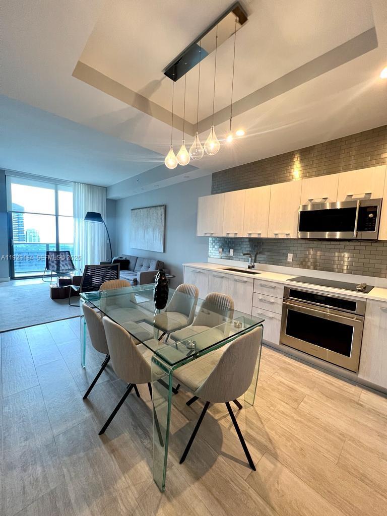 55 Southwest 9th Street, Unit 4205 Miami, FL 33130 - Photo 5 of 37 a kitchen with a stove a sink and a refrigerator