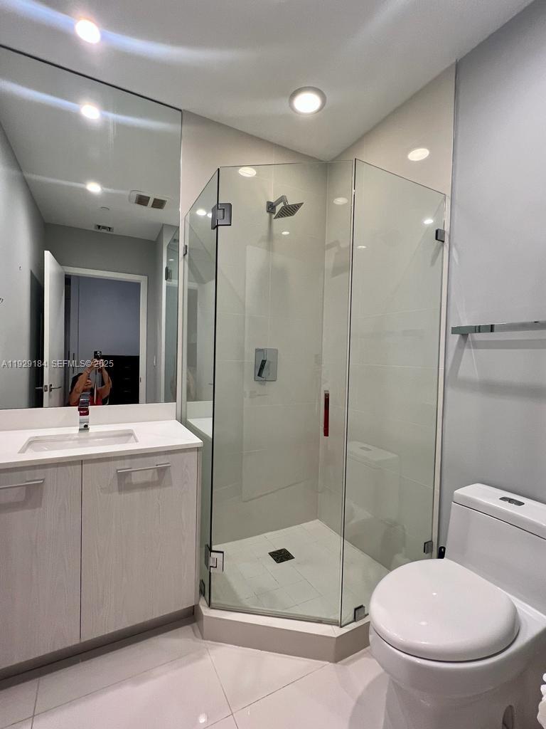 55 Southwest 9th Street, Unit 4205 Miami, FL 33130 - Photo 8 of 37 a bathroom with a shower sink mirror and toilet