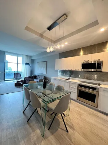 a kitchen with a stove a sink and a refrigerator
