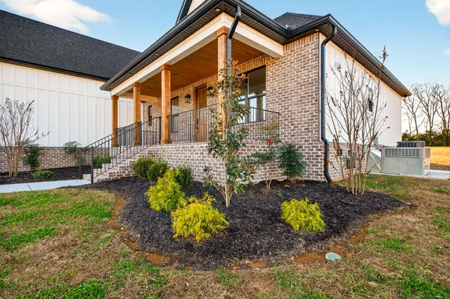 a front view of a house with garden