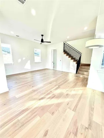 a view of a room with wooden floor