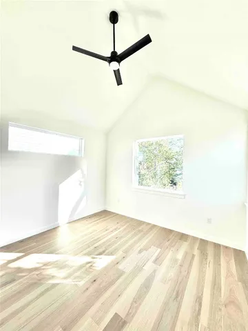 a view of a room with kitchen island and stainless steel appliances