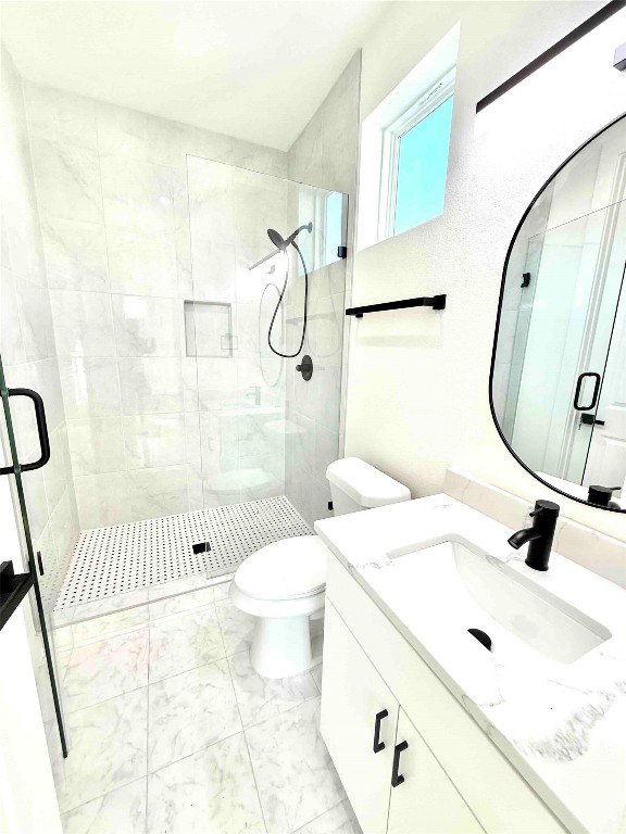 6809 Porter Street, Unit 2 Austin, TX 78741 - Photo 8 of 12 a bathroom with a sink toilet and shower