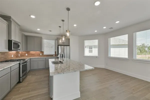 a large kitchen with granite countertop lots of counter space and window