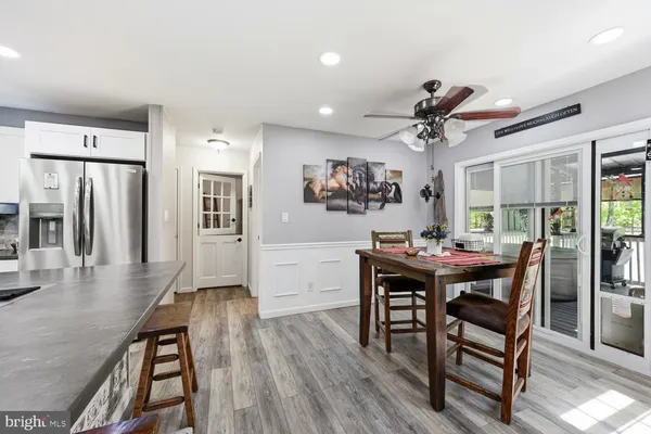 a view of a dining room with furniture and wooden floor