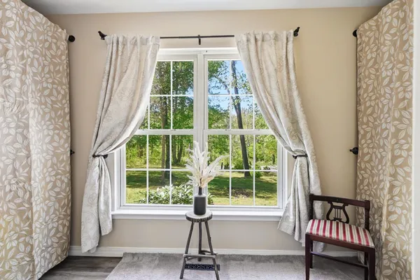 a view of a room with wooden floor and windows