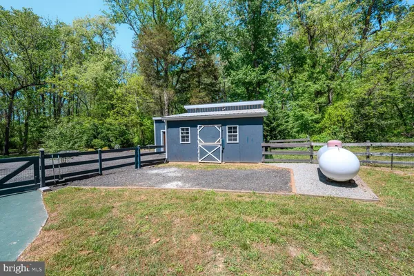 a view of a house with a backyard and a fire pit