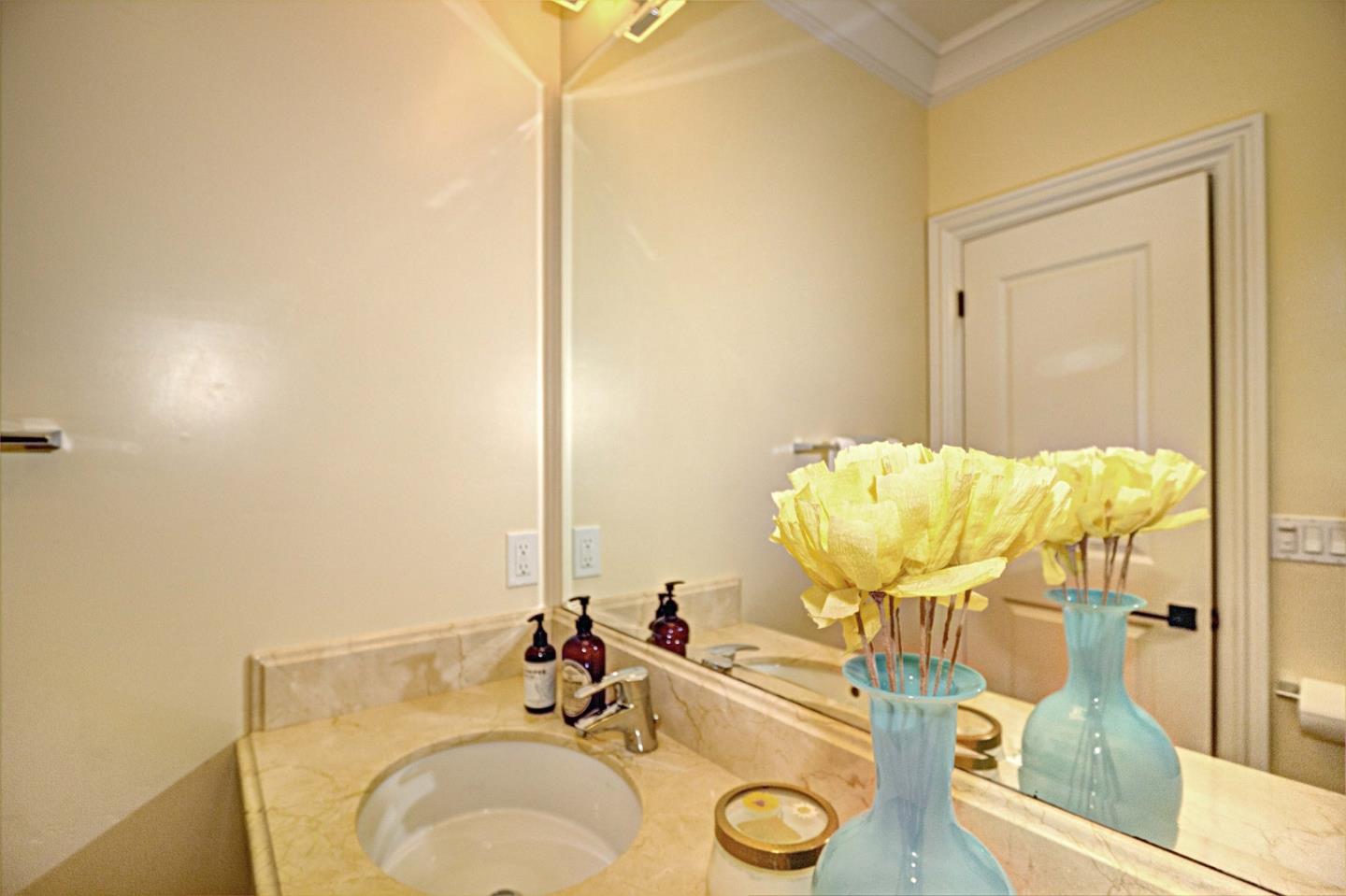 641 Mills Avenue Los Altos, CA 94022 - Photo 14 of 36 a bathroom with a granite countertop sink and a mirror