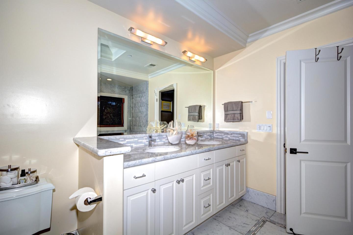 641 Mills Avenue Los Altos, CA 94022 - Photo 18 of 36 a spacious bathroom with a granite countertop toilet sink and mirror