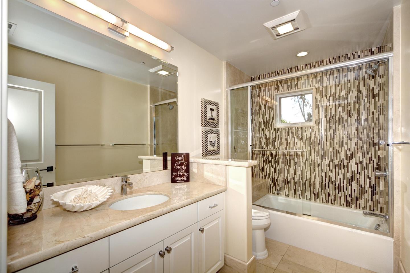 641 Mills Avenue Los Altos, CA 94022 - Photo 20 of 36 a bathroom with a granite countertop sink toilet and shower