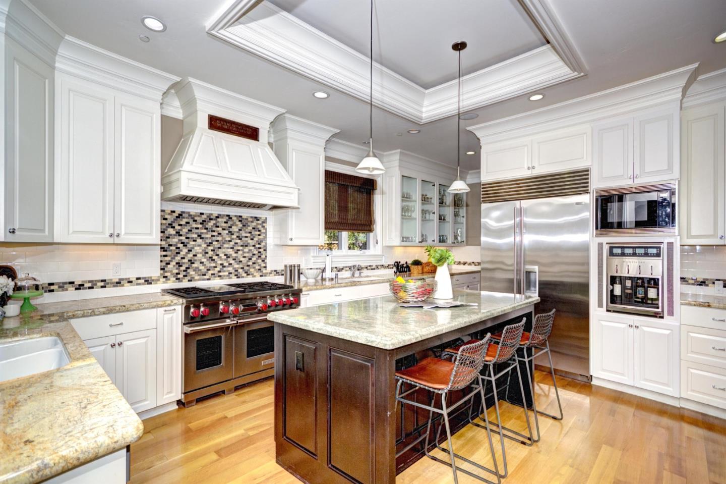641 Mills Avenue Los Altos, CA 94022 - Photo 10 of 36 a kitchen with stainless steel appliances granite countertop a stove top oven a sink dishwasher and a refrigerator with wooden floor