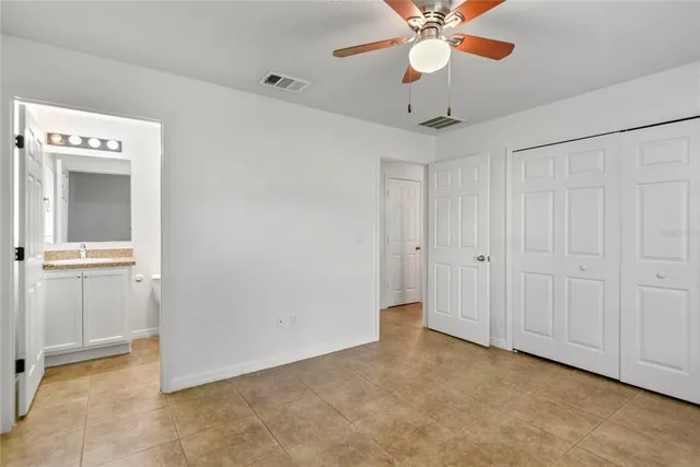 a view of an empty room with a ceiling fan