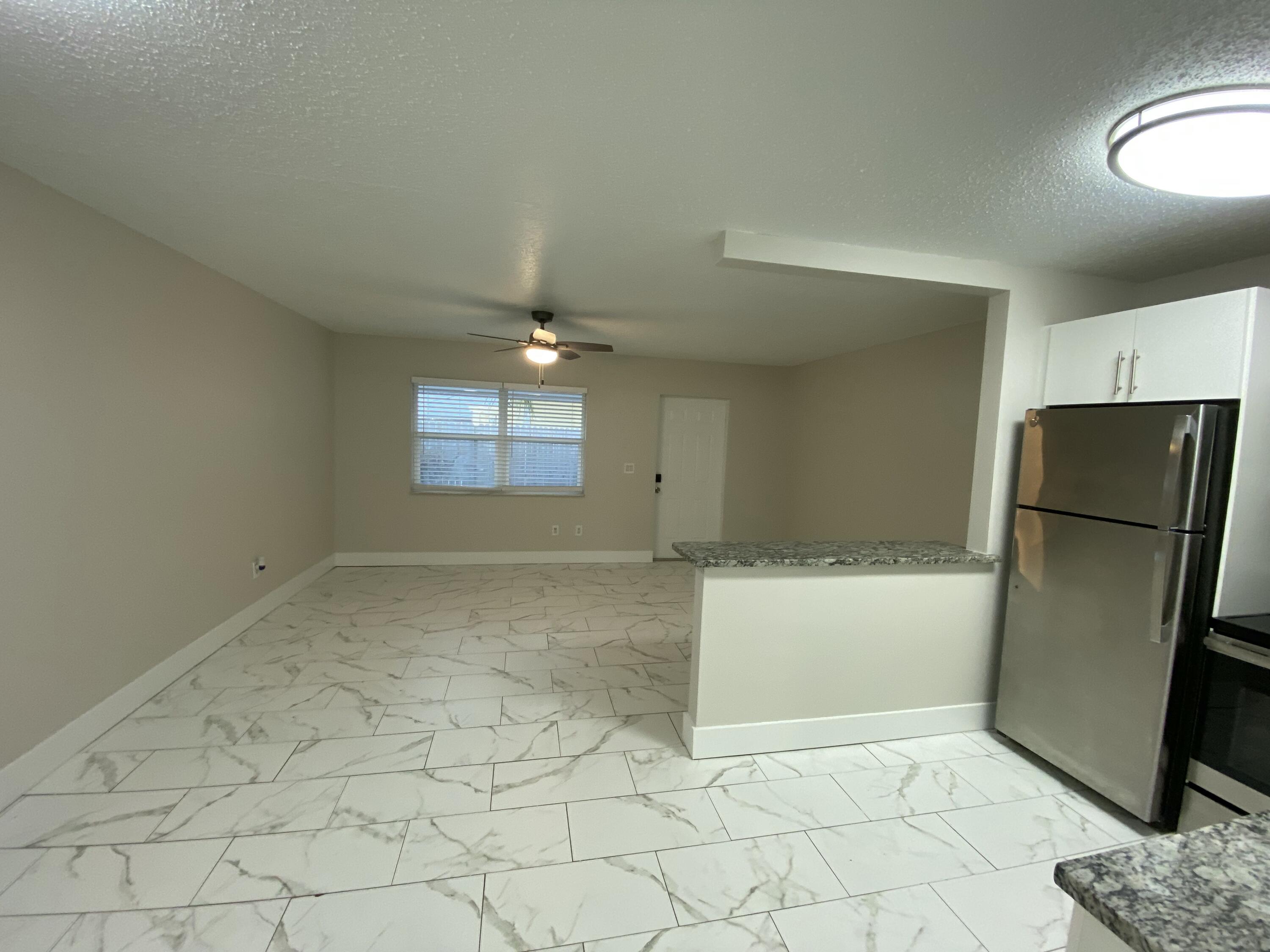 914 North Federal Highway, Unit 2 Lake Worth Beach, FL 33460 - Photo 5 of 13 an empty room with a fireplace