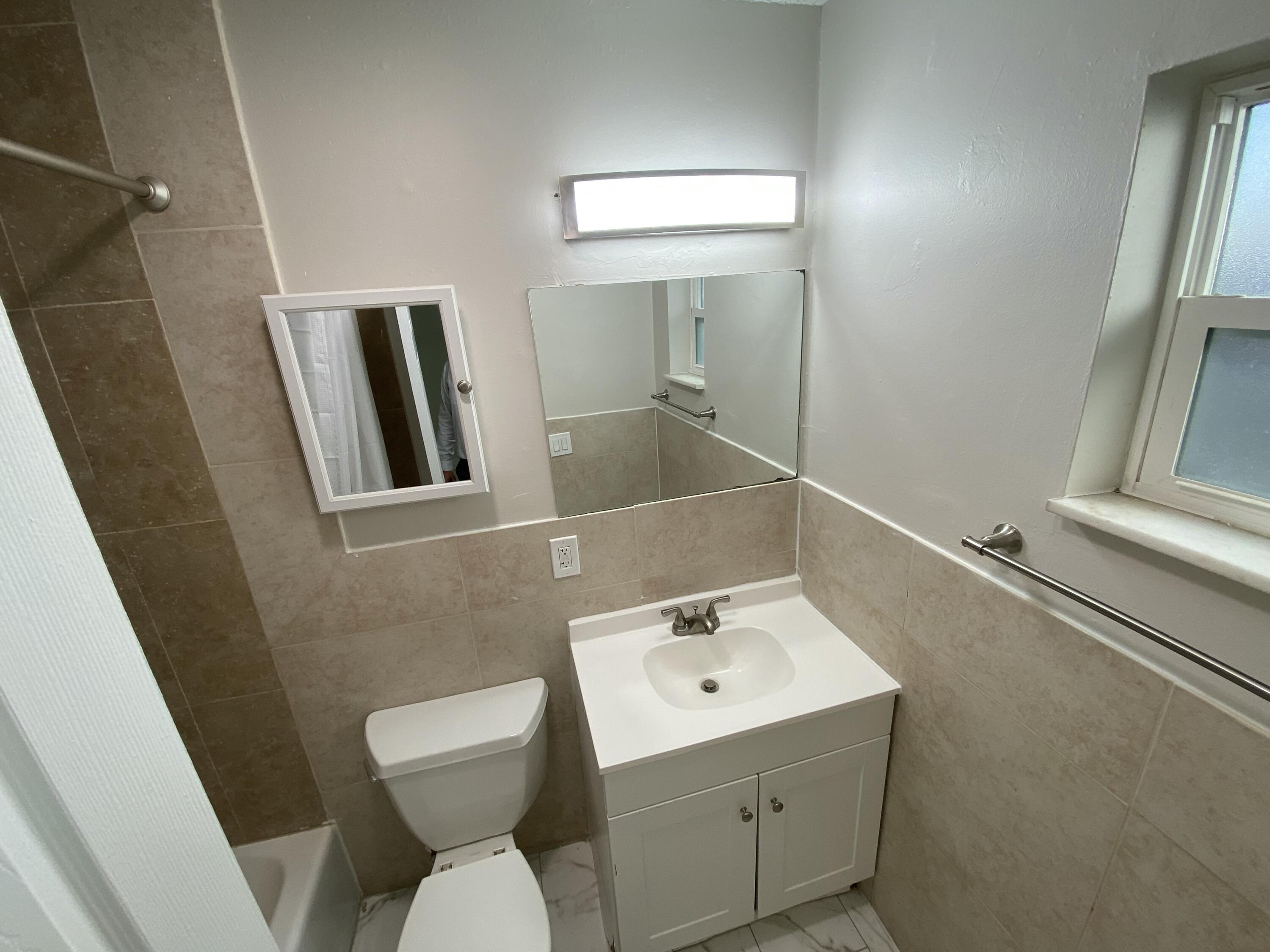 914 North Federal Highway, Unit 2 Lake Worth Beach, FL 33460 - Photo 8 of 13 a bathroom with a toilet sink and mirror