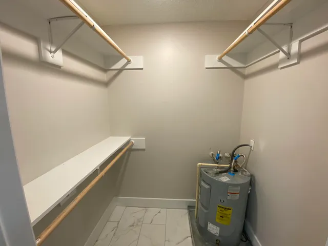 a view of backyard with plants and a wooden fence