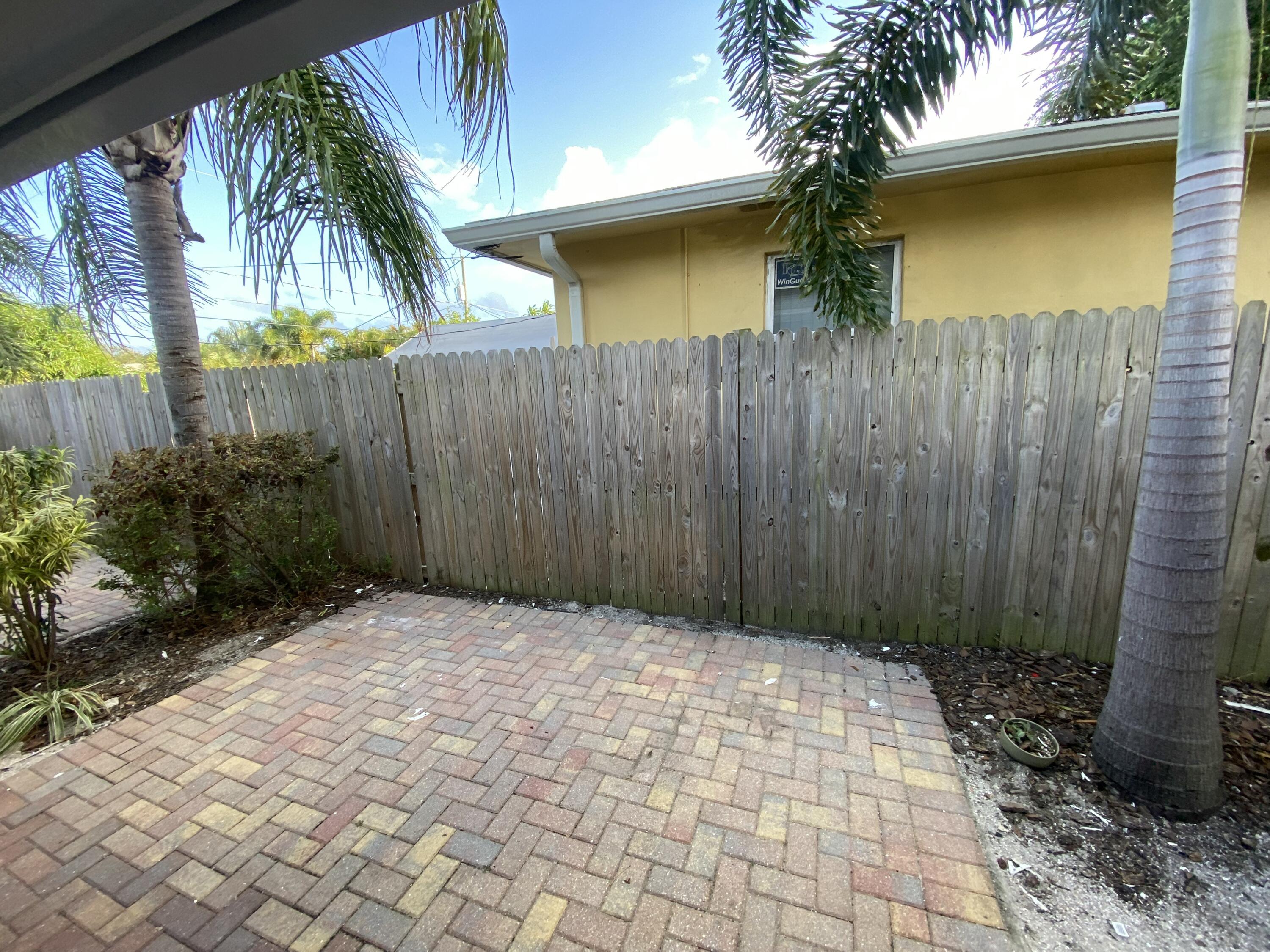 914 North Federal Highway, Unit 2 Lake Worth Beach, FL 33460 - Photo 10 of 13 a view of backyard with plants and a wooden fence