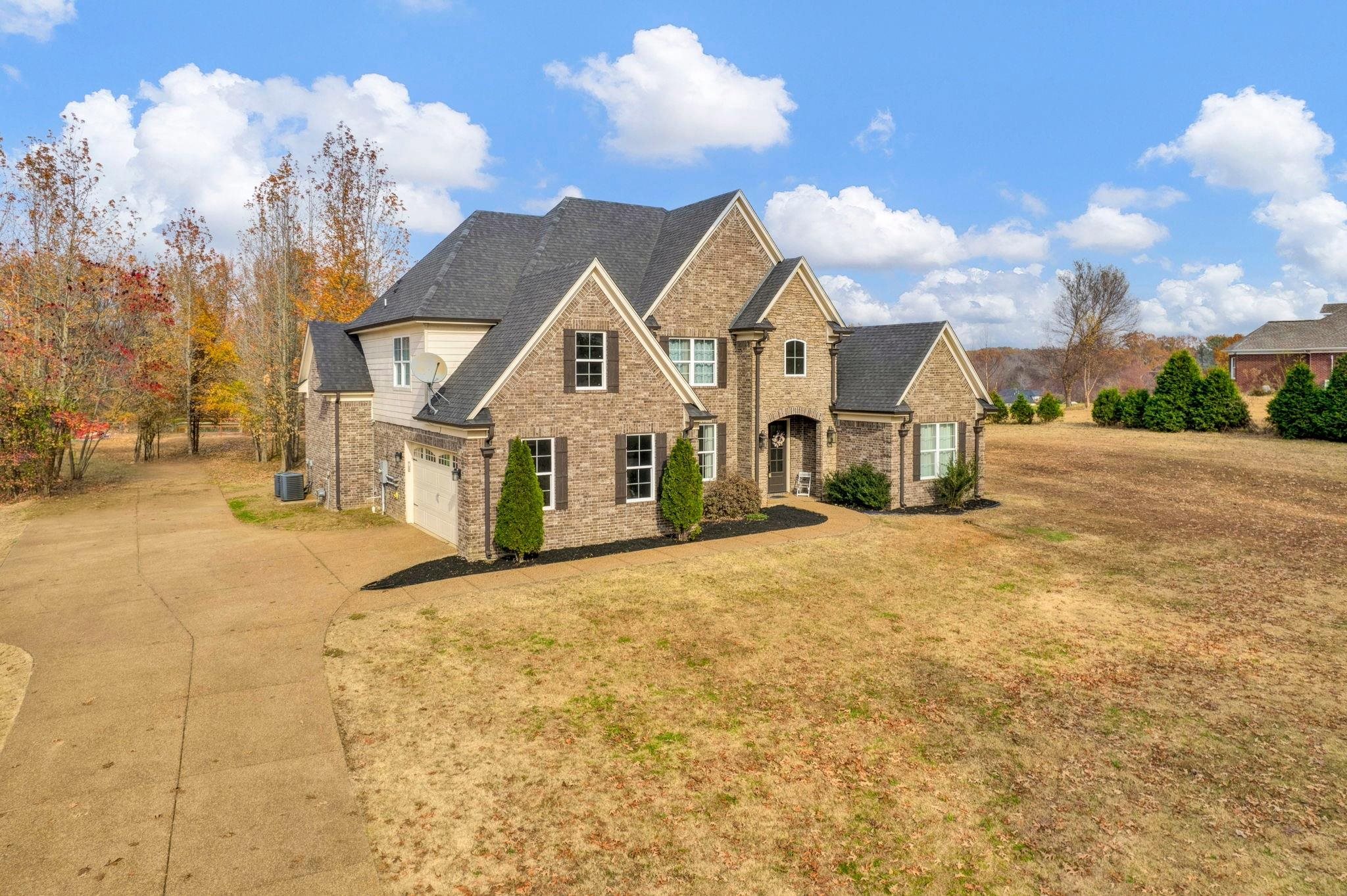 3270 Rast Road Millington, TN 38053 - Photo 3 of 40 Traditional-style house featuring a front yard, concrete driveway, a shingled roof, and brick siding