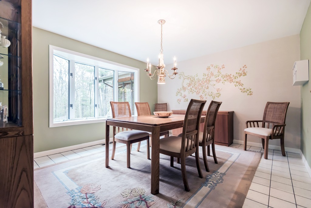 10 Regis Road Andover, MA 01810 - Photo 10 of 30 a dining room with furniture a chandelier and wooden floor