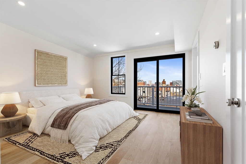 300 West 3rd Street, Unit 300 Boston, MA 02127 - Photo 11 of 23 a spacious bedroom with a bed a couch and a window