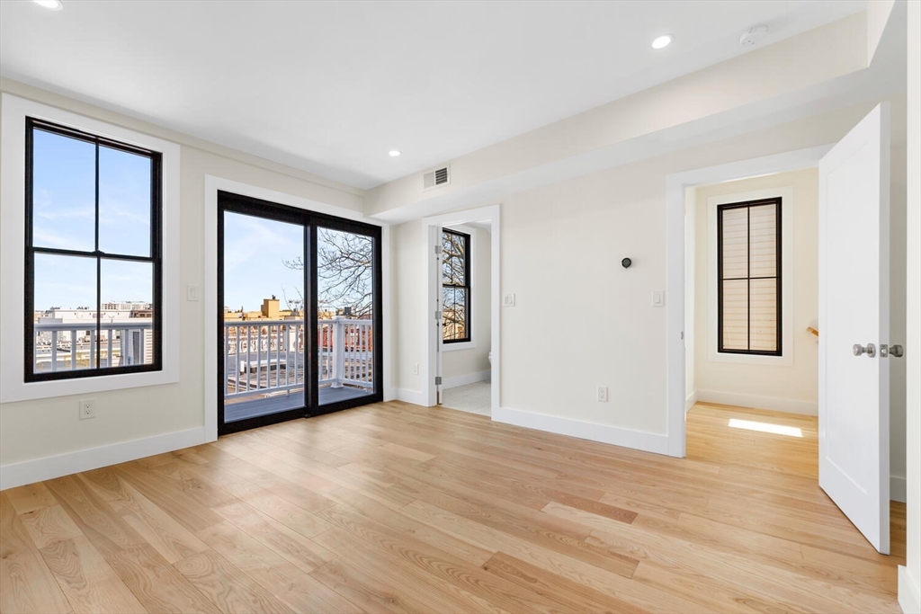 300 West 3rd Street, Unit 300 Boston, MA 02127 - Photo 12 of 23 a view of an empty room with window and wooden floor