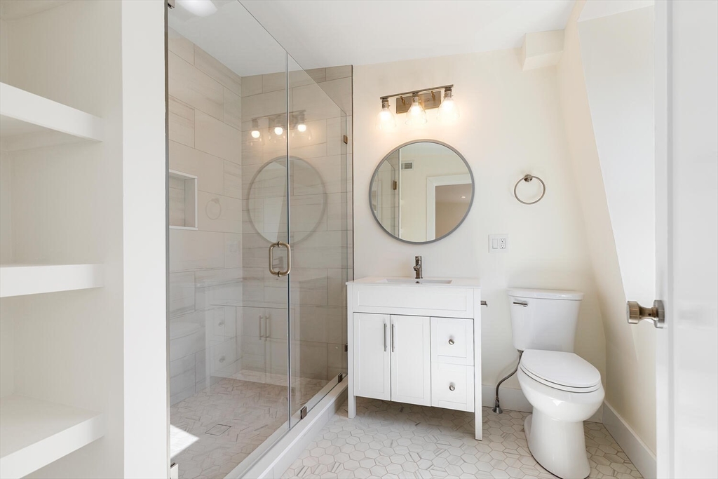 300 West 3rd Street, Unit 300 Boston, MA 02127 - Photo 17 of 23 a bathroom with a toilet a sink and a mirror
