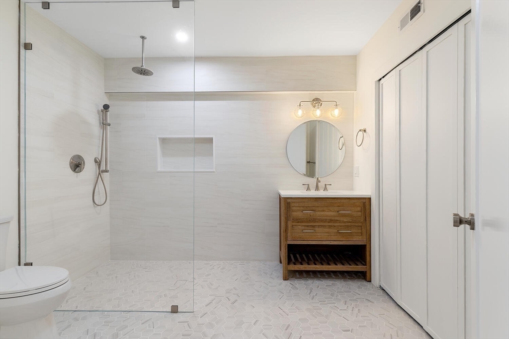 300 West 3rd Street, Unit 300 Boston, MA 02127 - Photo 20 of 23 a bathroom with a shower a sink and a mirror