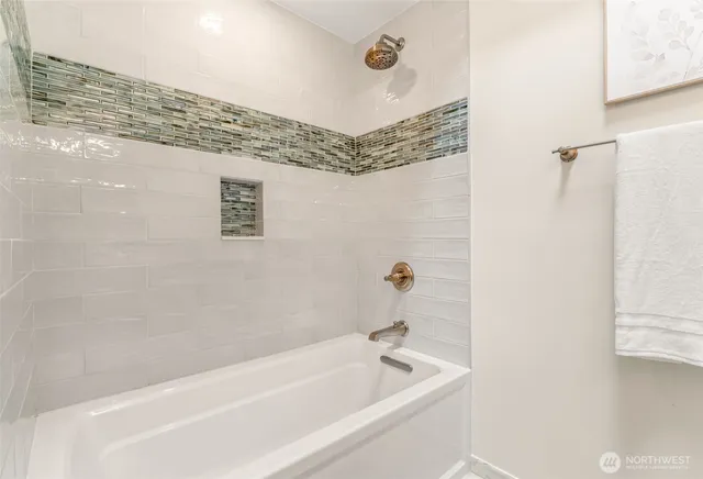 a bathroom with a bathtub and shower