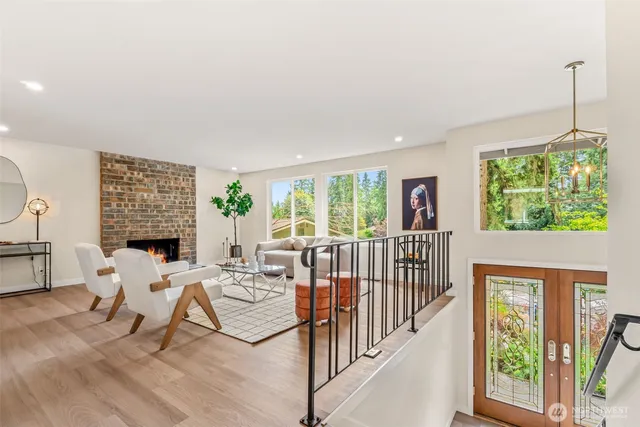 a living room with furniture floor to ceiling window and floor to ceiling window