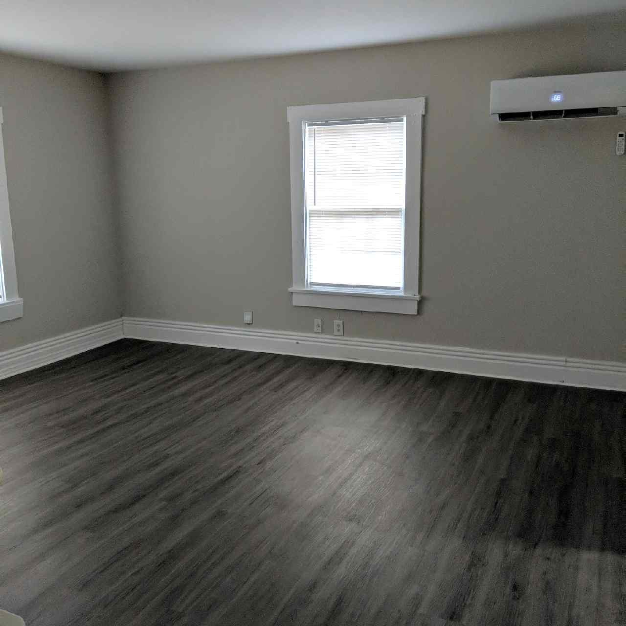 913 North Maple Street, Unit B Murfreesboro, TN 37130 - Photo 2 of 4 an empty room with wooden floor and windows