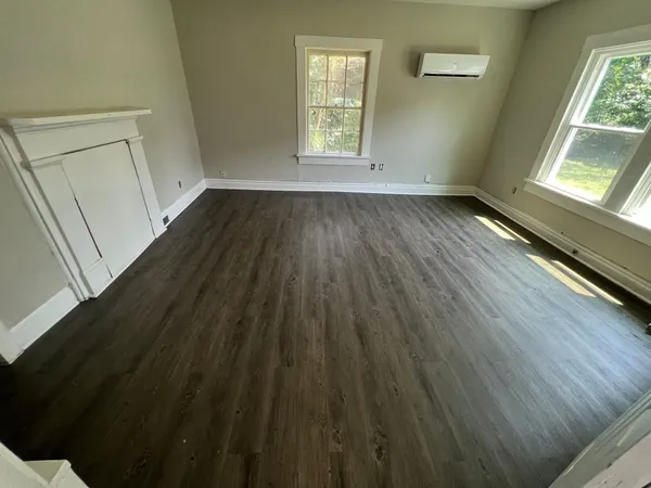 wooden floor in an empty room with a window