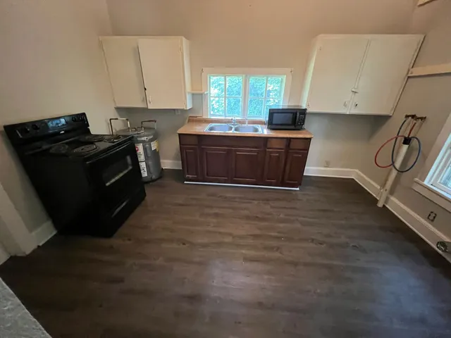 a kitchen with granite countertop a stove and a sink