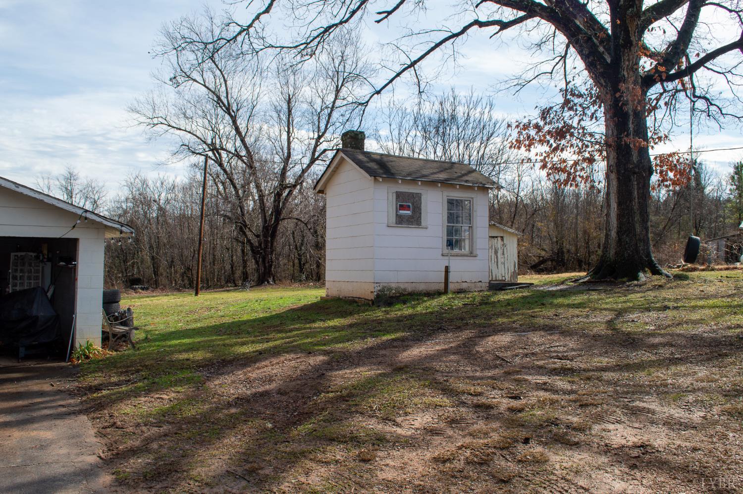 400 Prospect Road Hurt, VA 24563 - Photo 16 of 17 a backyard of a house with plants and large tree