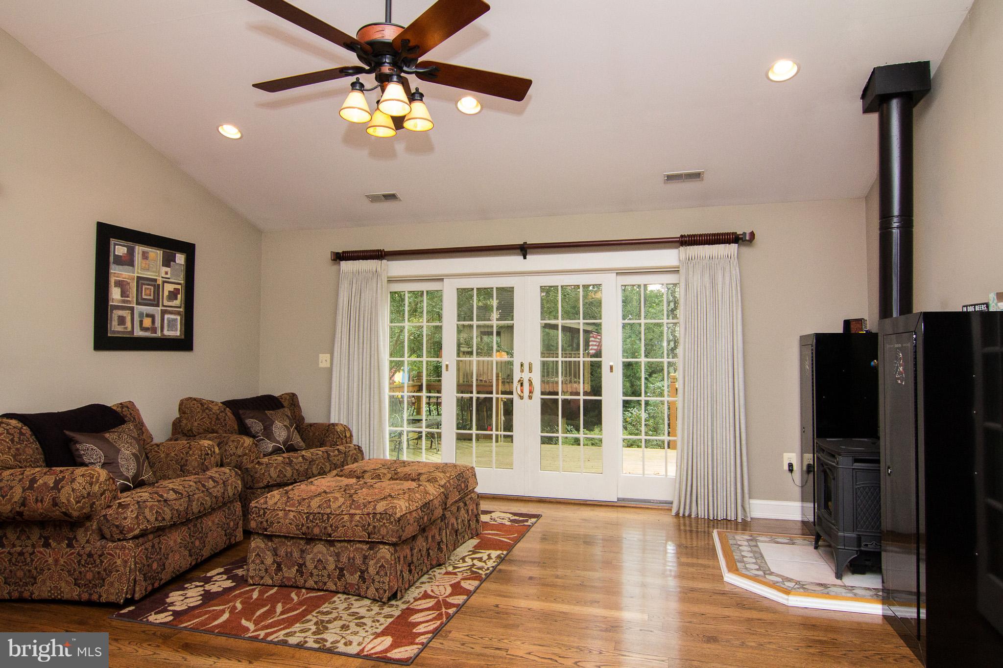 3915 St Paul Road Hampstead, MD 21074 - Photo 18 of 30 Sitting room with fireplace and doors to deck