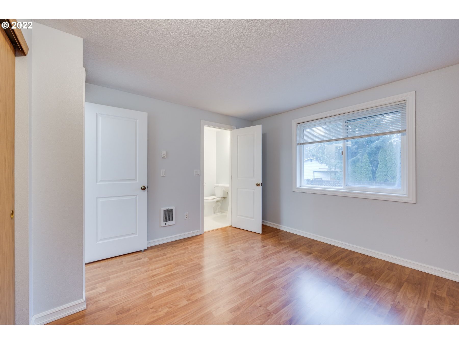 328 Sargent Street Ridgefield, WA 98642 - Photo 8 of 18 a view of an empty room with wooden floor and a window