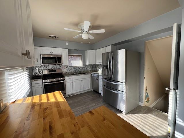 1035 Anderson Road Pittsburgh, PA 15209 - Photo 14 of 41 a kitchen with kitchen island granite countertop a refrigerator oven a sink dishwasher and white cabinets with wooden floor
