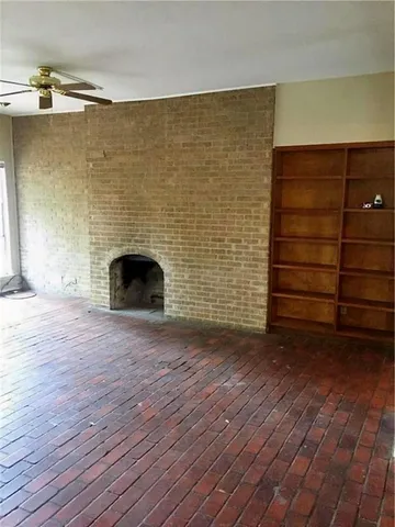 a view of an empty room with a fireplace