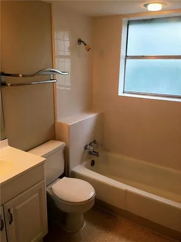 a bathroom with a toilet a sink and bathtub