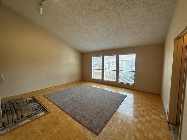 an empty room with kitchen view and empty room