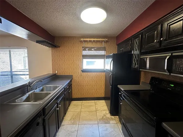 a view of a kitchen with a sink and a window