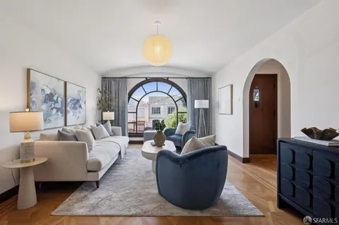 a living room with furniture and a large window
