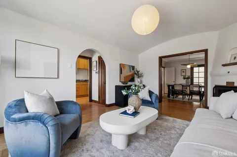 a large kitchen with stainless steel appliances granite countertop a lot of counter space and wooden floor