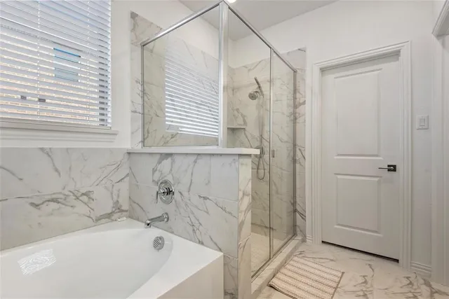 a bathroom with a bathtub and a shower