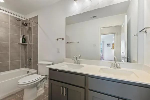 a bathroom with a sink toilet vanity and shower