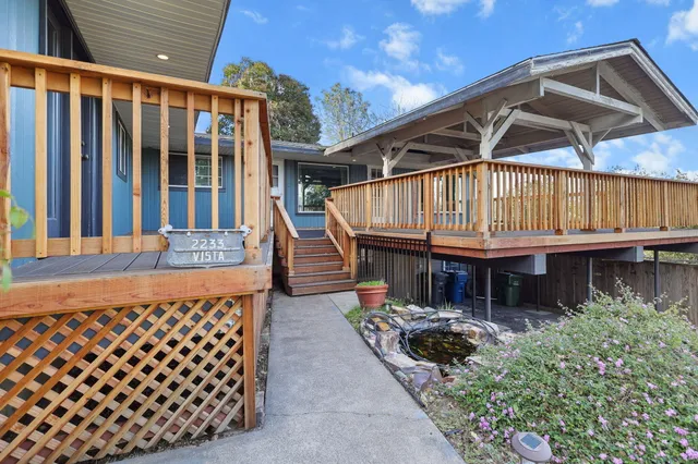 a backyard of a house with table and chairs