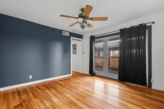 a view of a livingroom with a ceiling fan and window