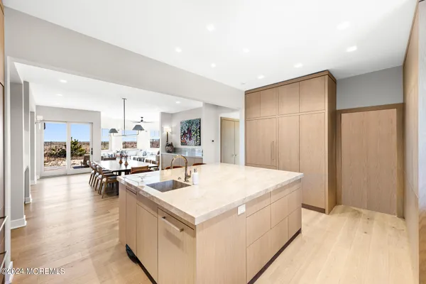 a living room with furniture white walls and a large window