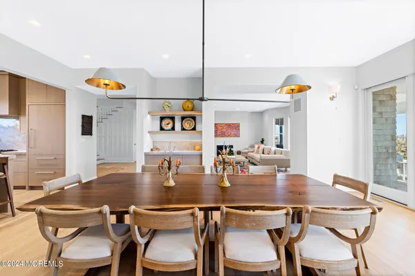 a living room with furniture and floor to ceiling windows