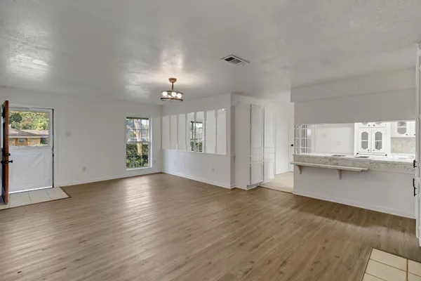 a view of a dining room with furniture and a window