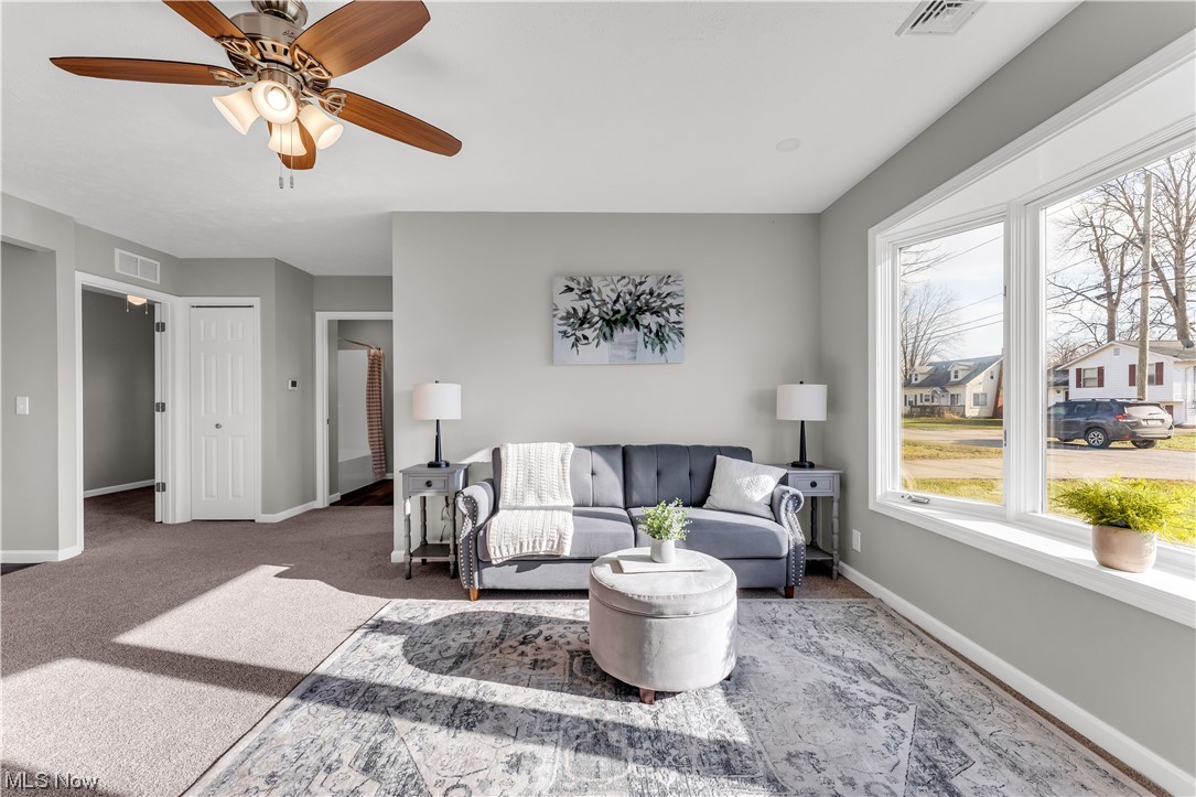 7501 Southland Road Mentor, OH 44060 - Photo 6 of 21 Carpeted living room featuring ceiling fan